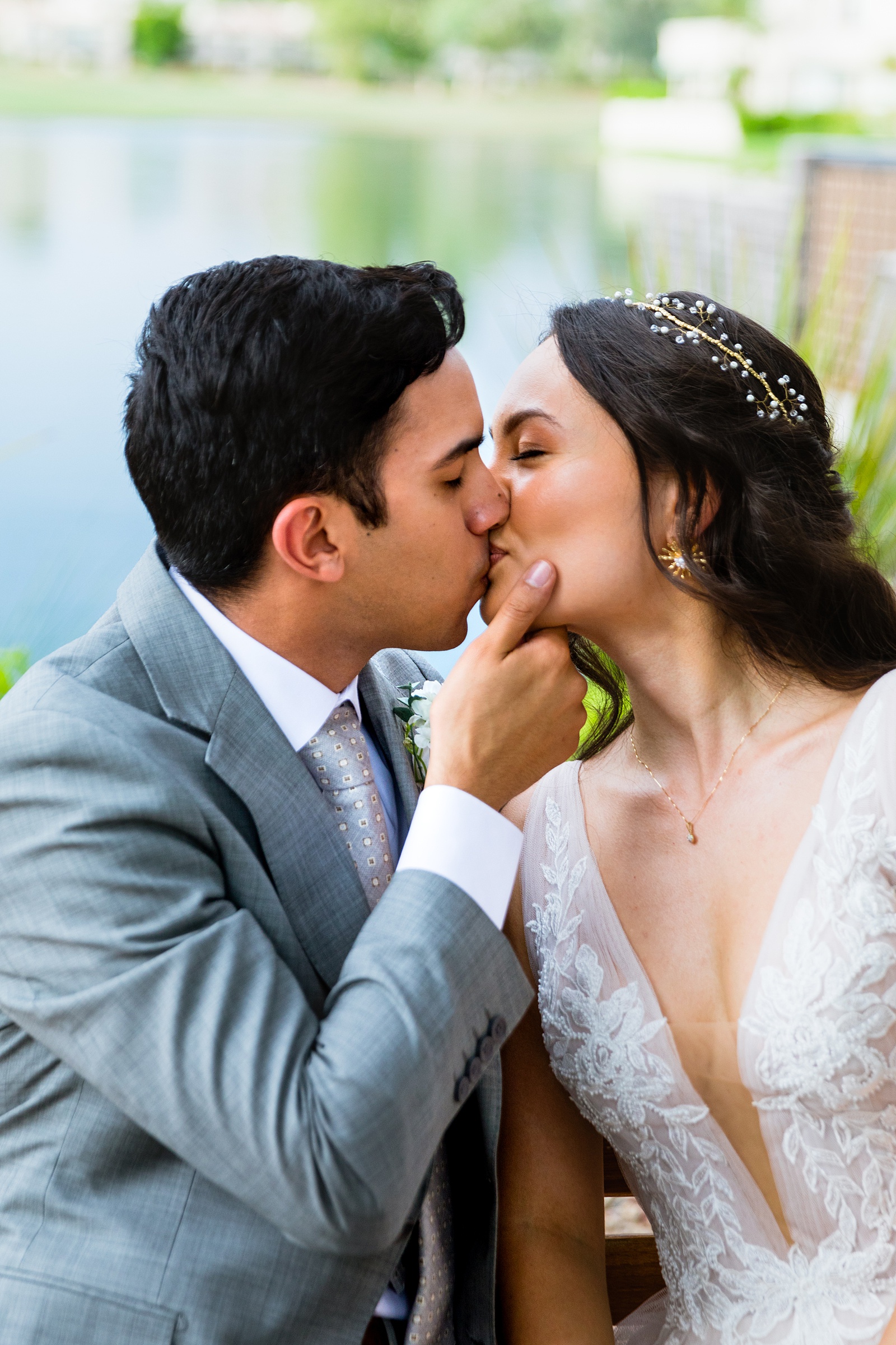 Bride and groom share a kiss during their Hyatt Regency Scottsdale Resort & Spa At Gainey Ranch wedding by Arizona wedding photographer PMA Photography.