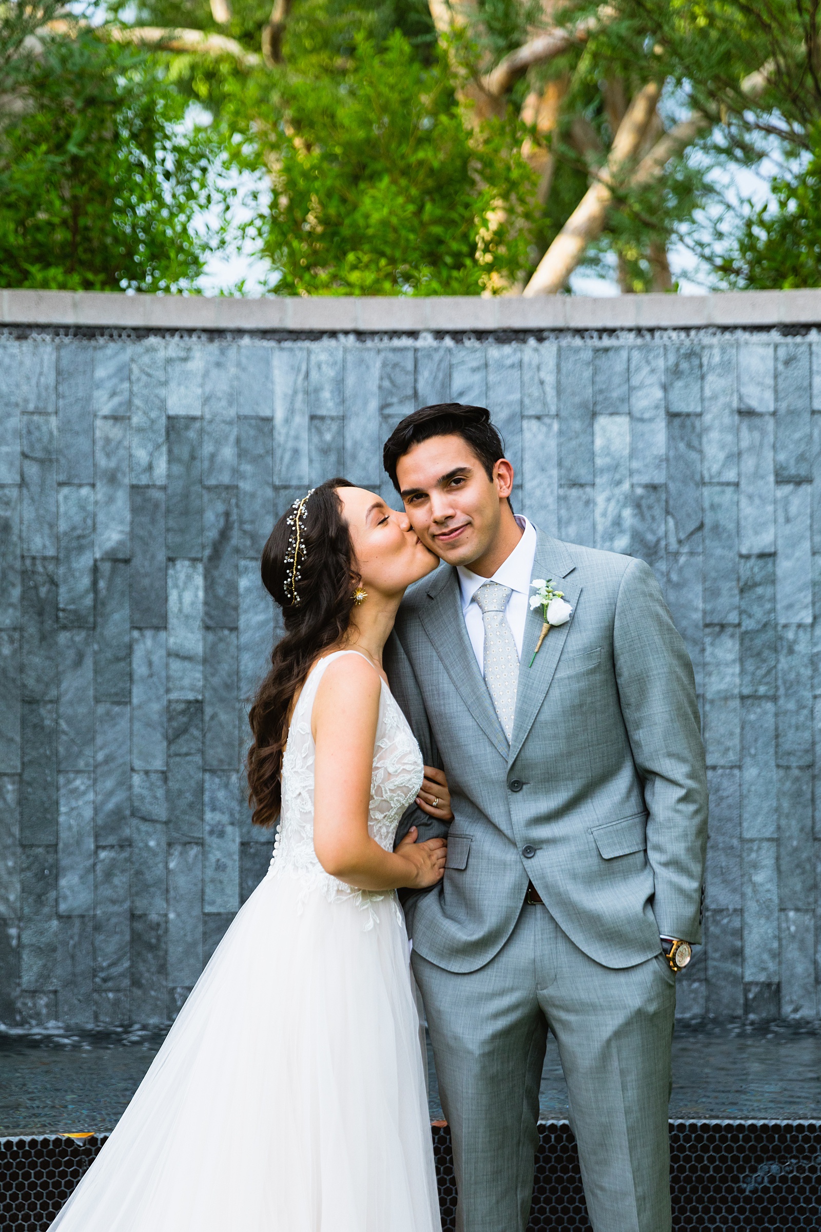 Bride and groom share a kiss during their Hyatt Regency Scottsdale Resort & Spa At Gainey Ranch wedding by Scottdsale wedding photographer PMA Photography.