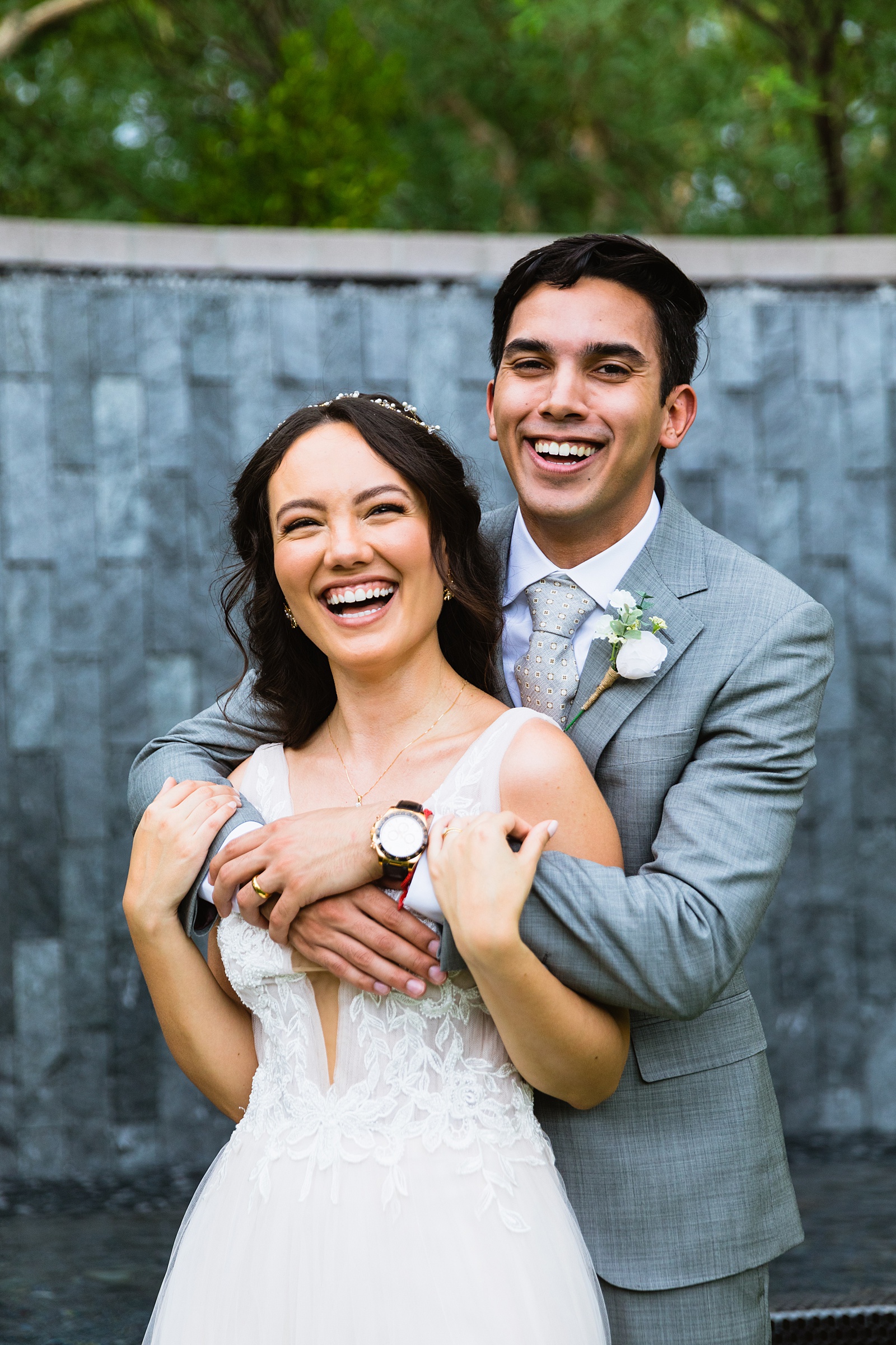 Bride and groom laughing together during their Hyatt Regency Scottsdale Resort & Spa At Gainey Ranch wedding by Scottdsale wedding photographer PMA Photography.