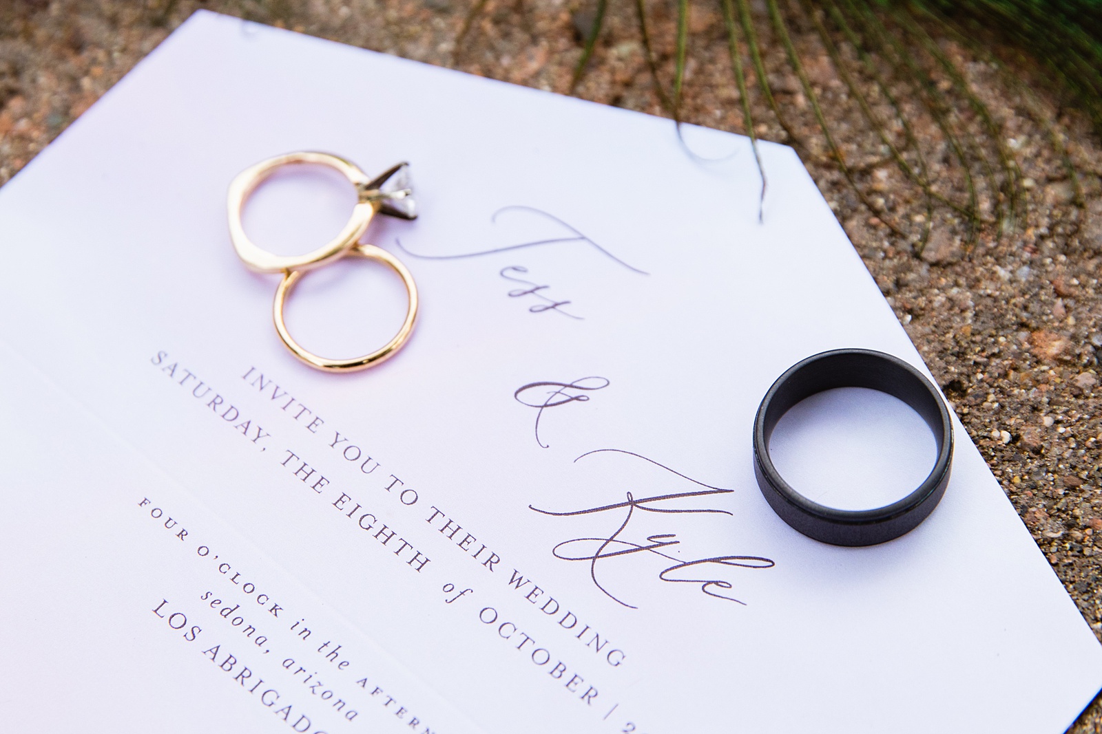 Bride and Groom's wedding day details of invitation and wedding bands by PMA Photography.