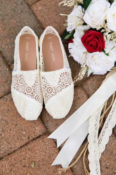 Bride's wedding day details of lace shoes and bouquet by PMA Photography.