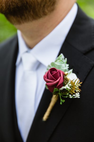 Groom's wedding day details of boutonniere by PMA Photography.
