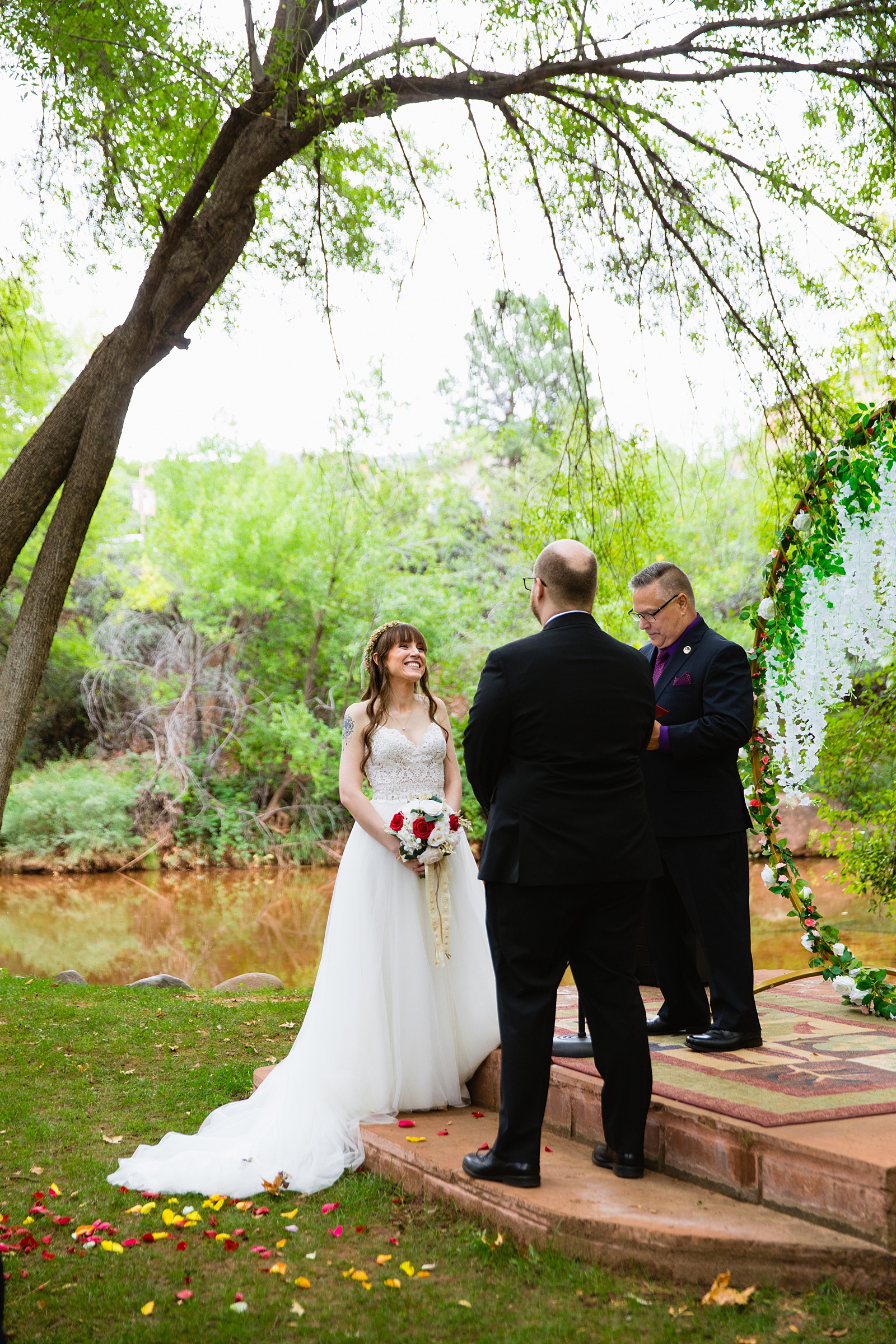 Bride looking at her groom during their wedding ceremony at Los Abrigados by Sedona wedding photographer PMA Photography.
