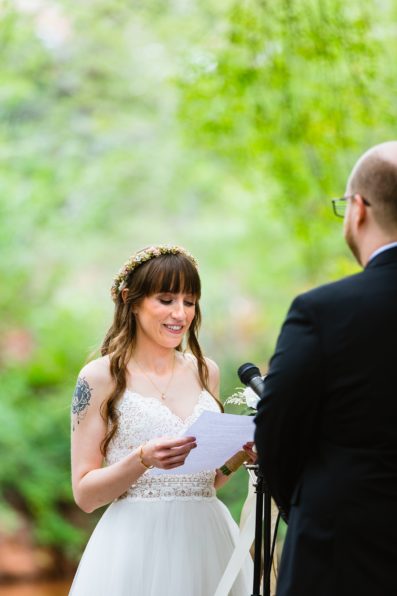 Bride and Groom exchange vows during their Los Abrigados wedding ceremony by Sedona wedding photographer PMA Photography.