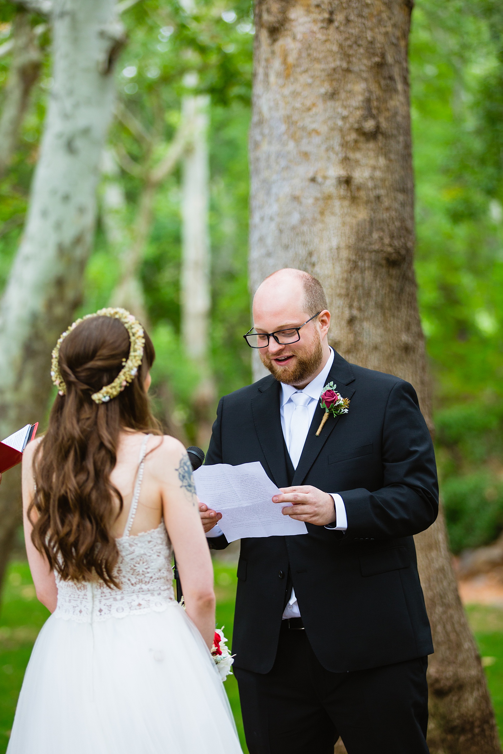 Bride and Groom exchange vows during their Los Abrigados wedding ceremony by Sedona wedding photographer PMA Photography.