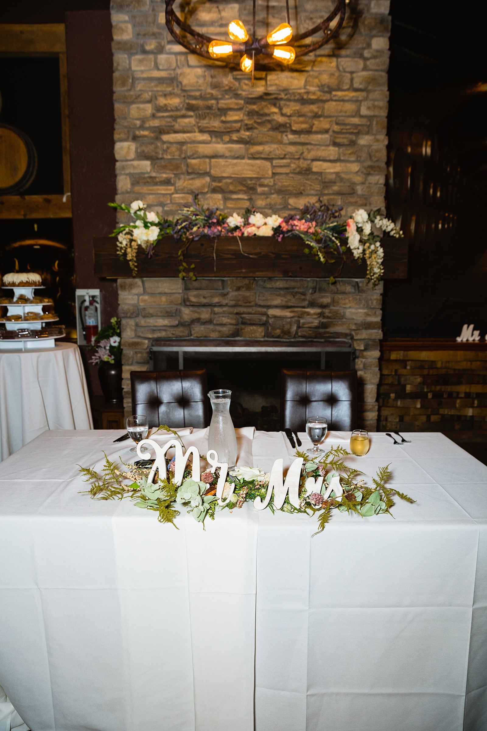 Sweetheart table at Timo Wood Oven Wine Bar wedding reception by Arizona wedding photographer PMA Photography.