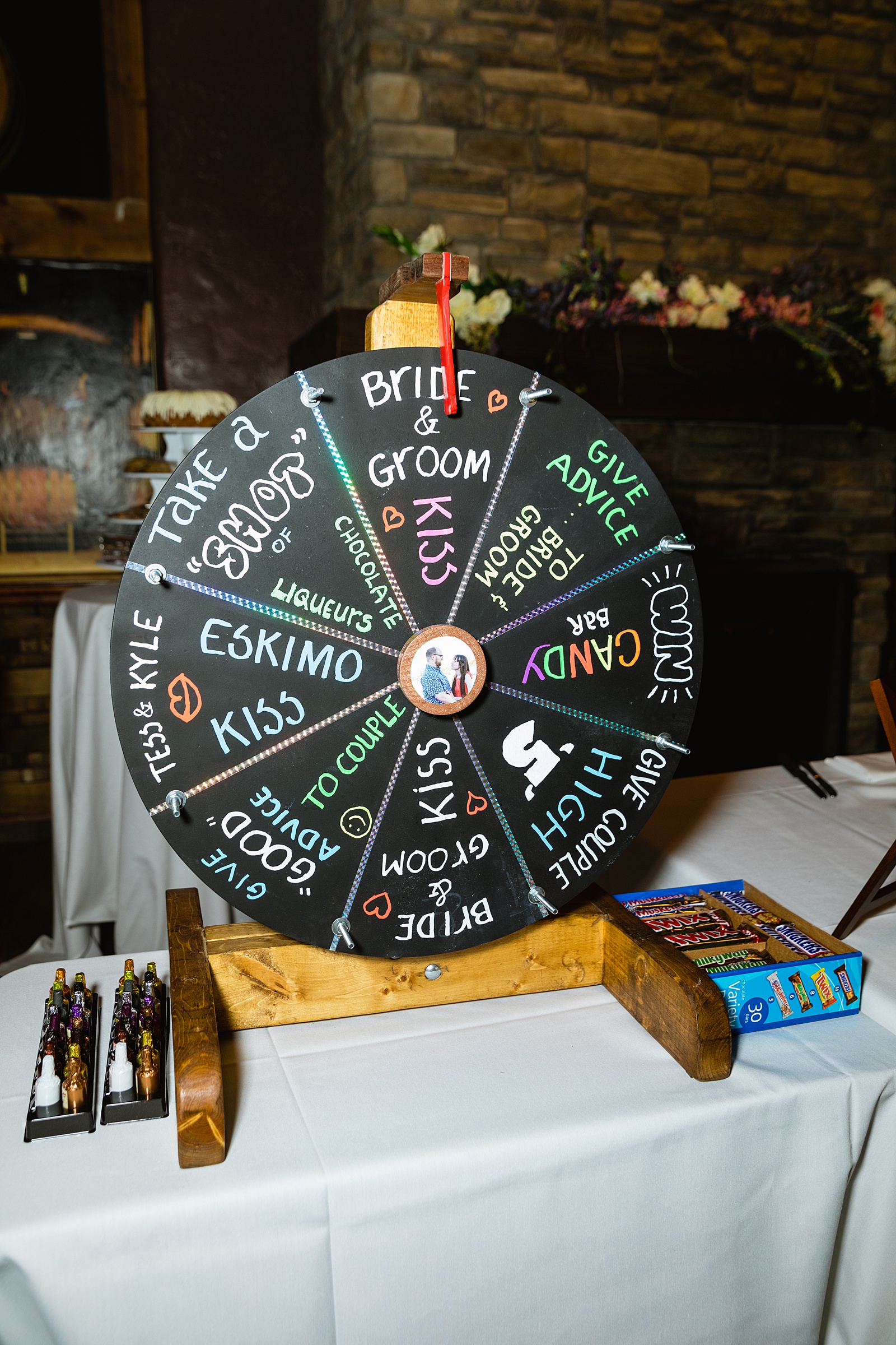 Spin the wheel game and decorations at Timo Wood Oven Wine Bar wedding reception by Sedona wedding photographer PMA Photography.
