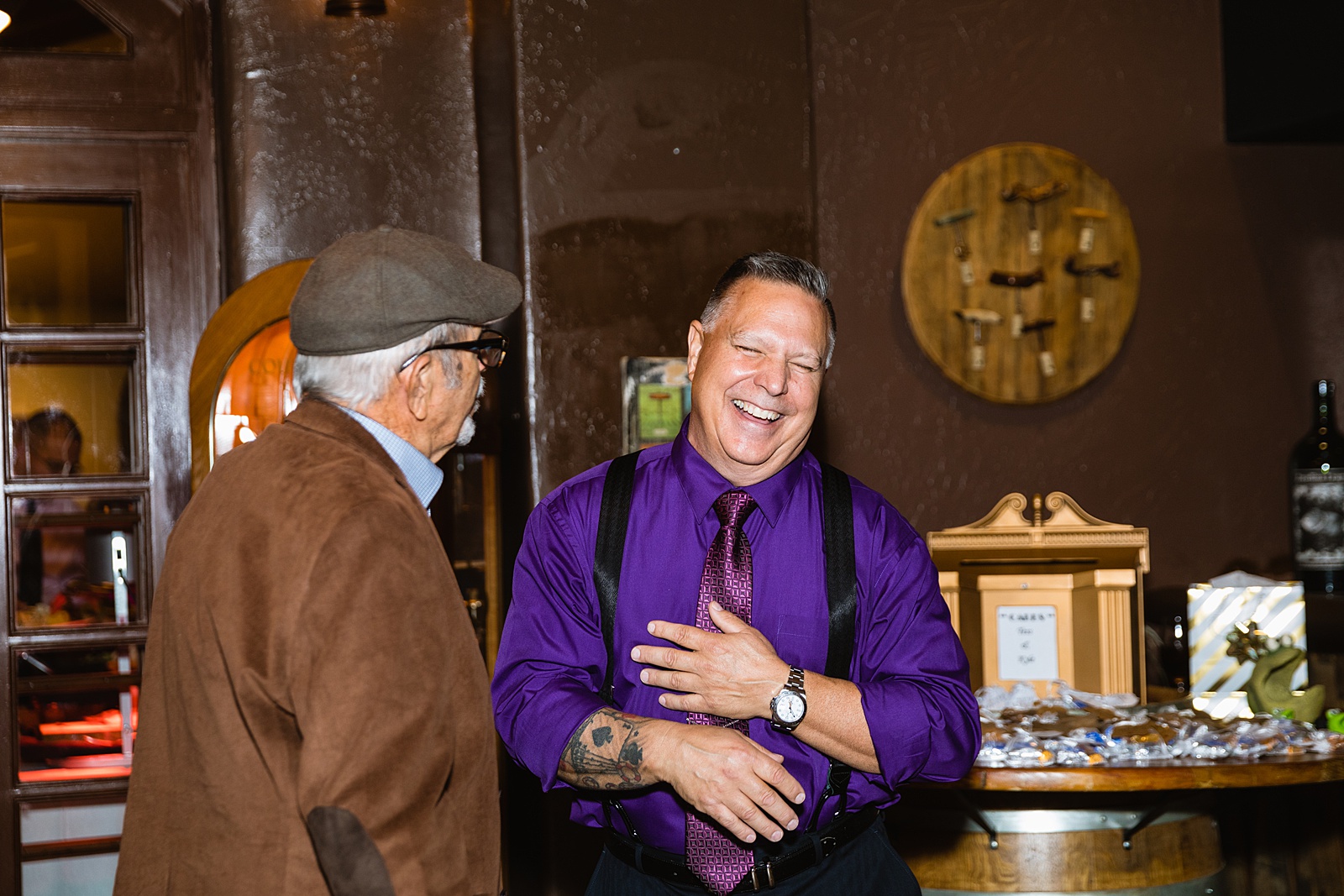 Guests laughing together at Timo Wood Oven Wine Bar wedding reception by Sedona wedding photographer PMA Photography