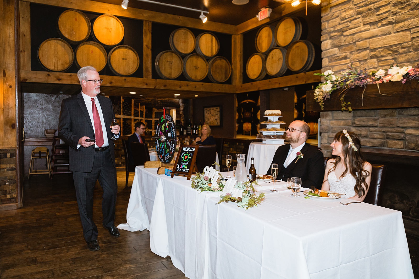 Bride and Groom share a toast with their guests at their Timo Wood Oven Wine Bar wedding reception by Arizona wedding photographer PMA Photography.