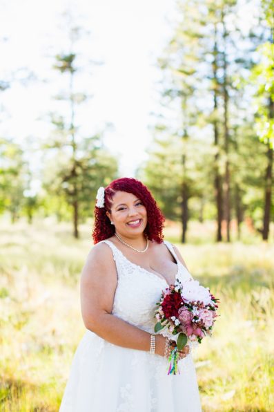 Bride's traditional wedding dress and bouquet for her Mogollon Rim elopement by PMA Photography.