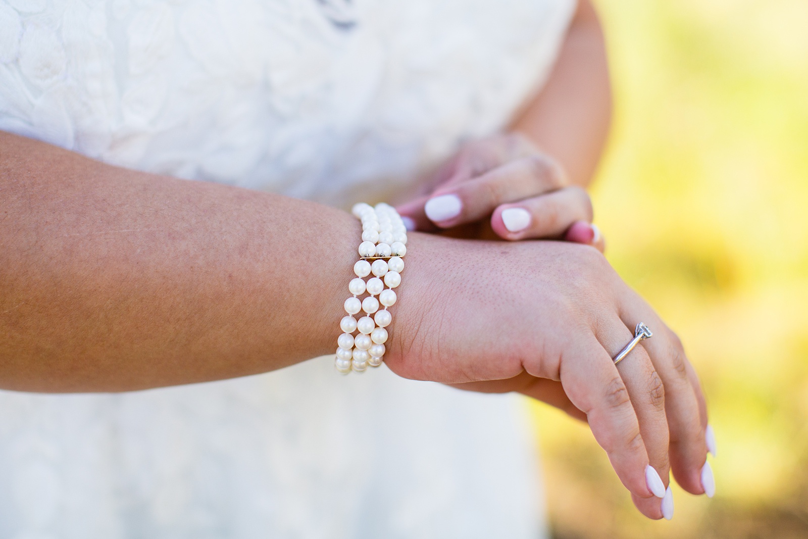 Brides's wedding day details of simple pearl bracelet by PMA Photography.