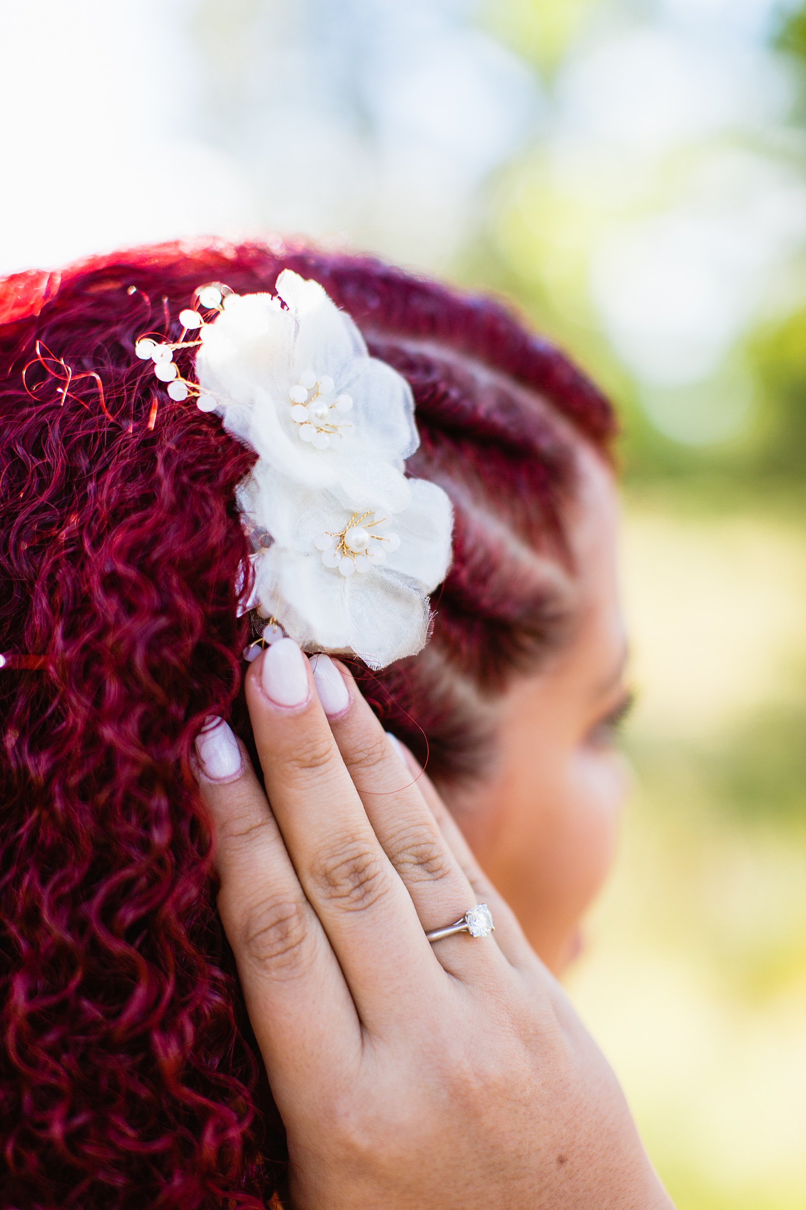 Brides's wedding day details of white flower hair piece in red hair by PMA Photography.