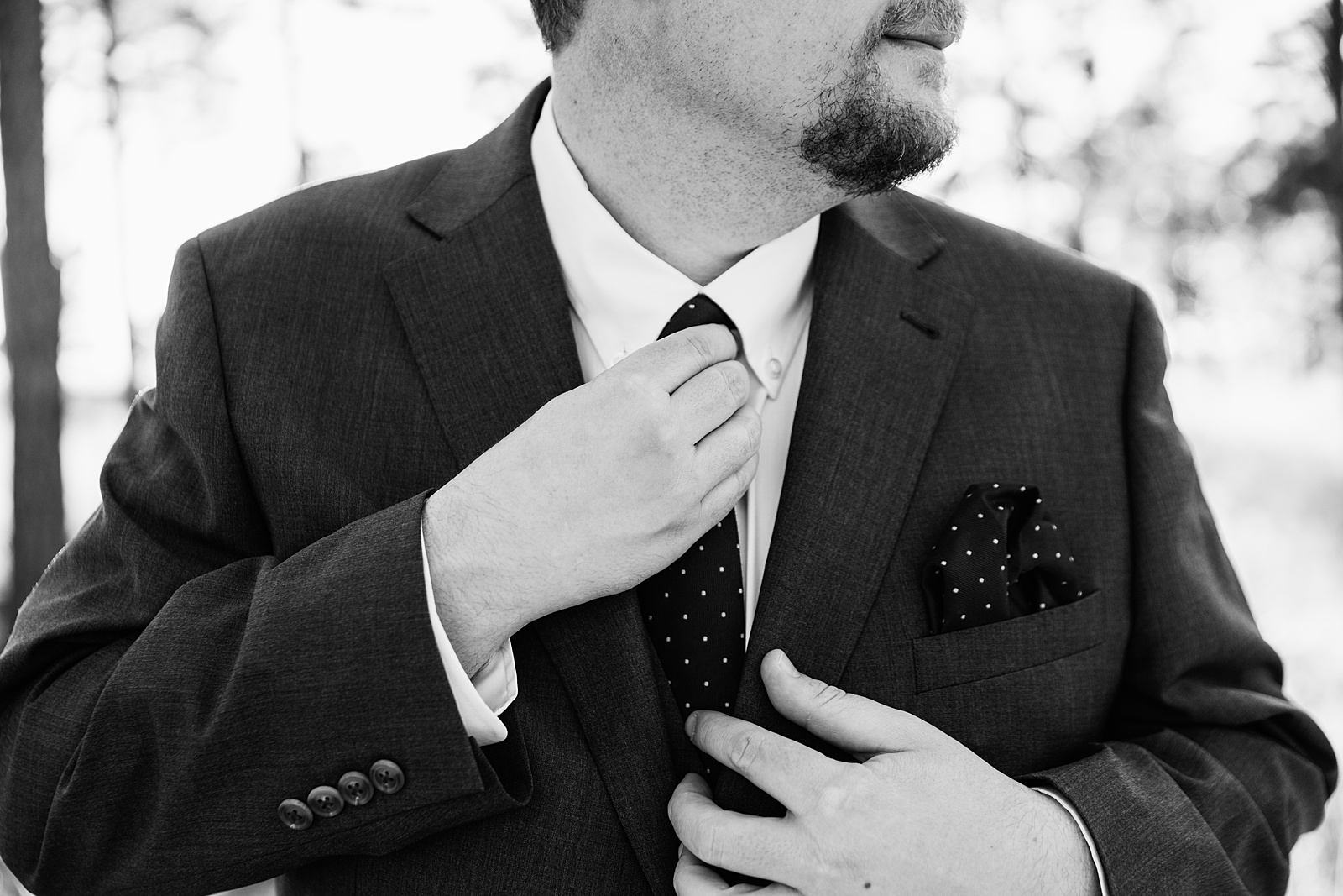 Groom's suit with polka dot tie and pocket square for his Mogollon Rim elopement by PMA Photography.