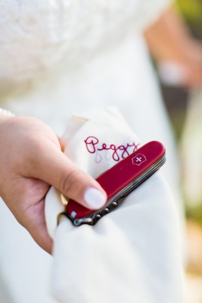 Brides's wedding day details of personalized handkerchief and swiss army knife by PMA Photography.