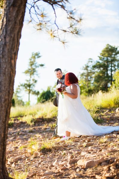 Bride walking down aisle with her groom during Mogollon Rim wedding ceremony by Arizona elopement photographer PMA Photography.