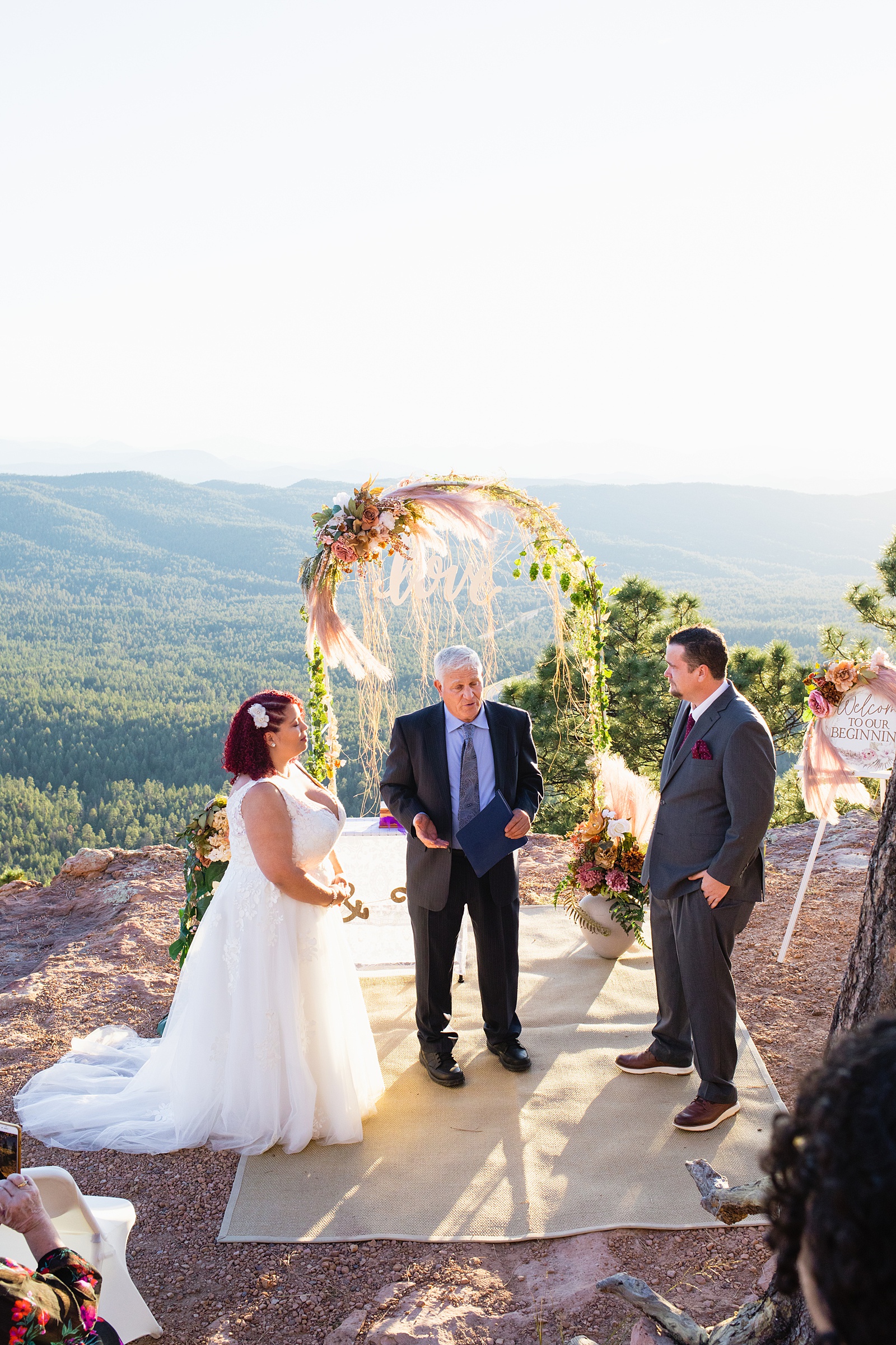 Groom looking at his bride during their wedding ceremony at Mogollon Rim by Northern Arizona elopement photographer PMA Photography.