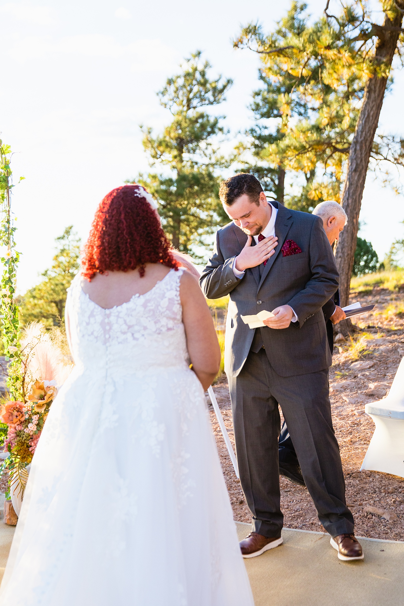 Adventurous couple exchange vows during their wedding ceremony at Mogollon Rim by Arizona elopement photographer PMA Photography.