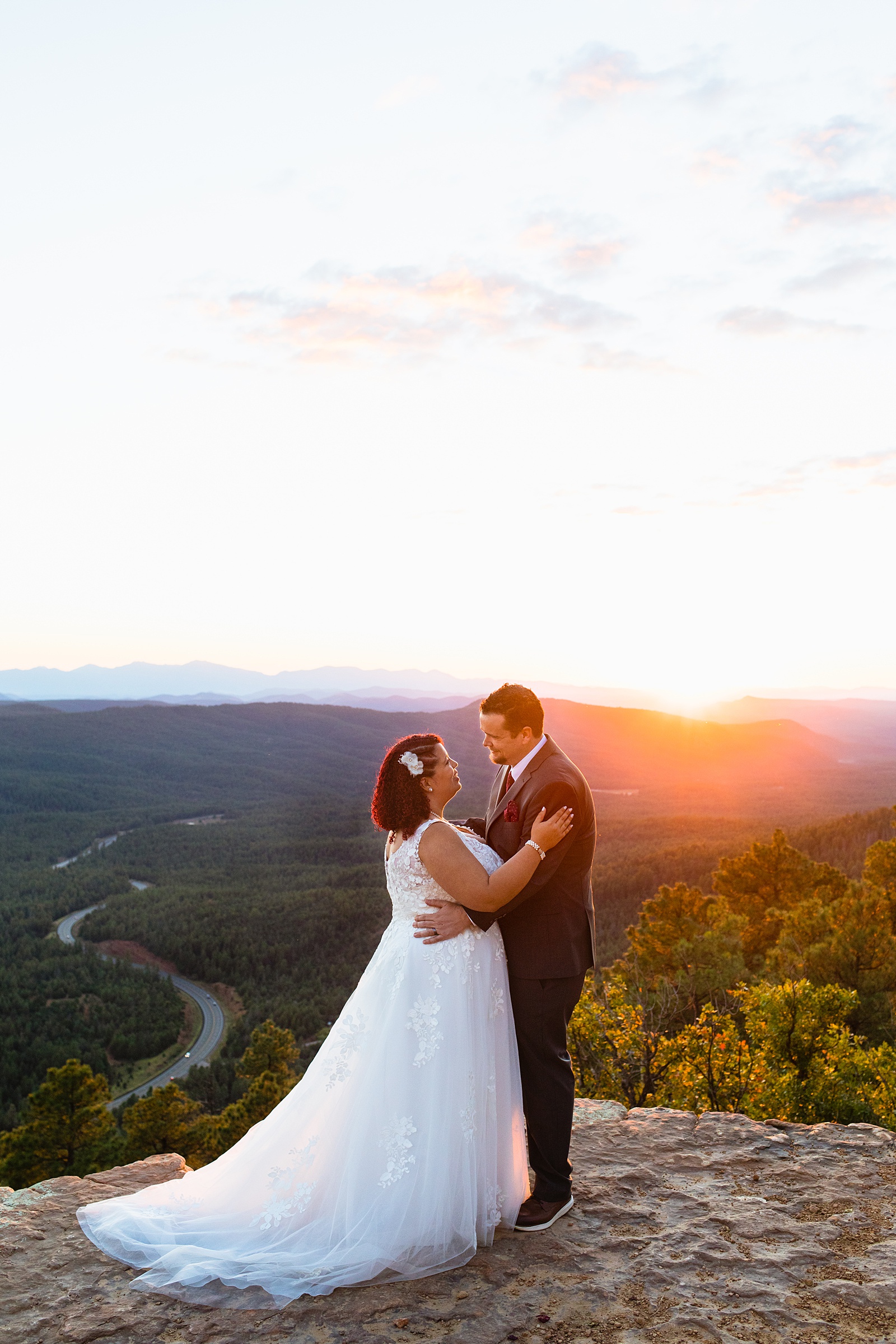 Adventurous couple looking at each other during sunset at their Mogollon Rim elopement by Northern Arizona elopement photographer PMA Photography.