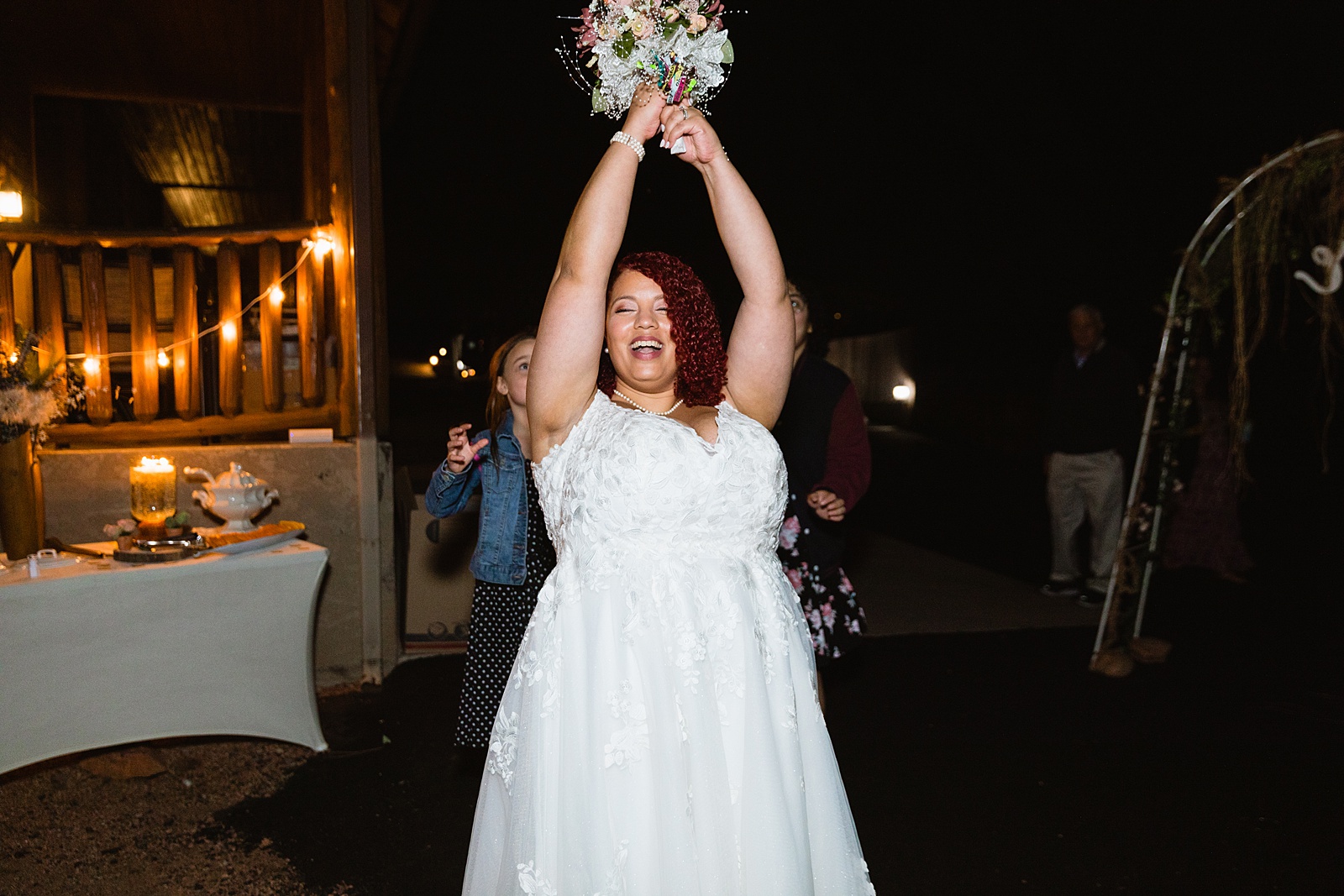 Bouquet toss at Mogollon Rim wedding reception by Northern Arizona wedding photographer PMA Photography.