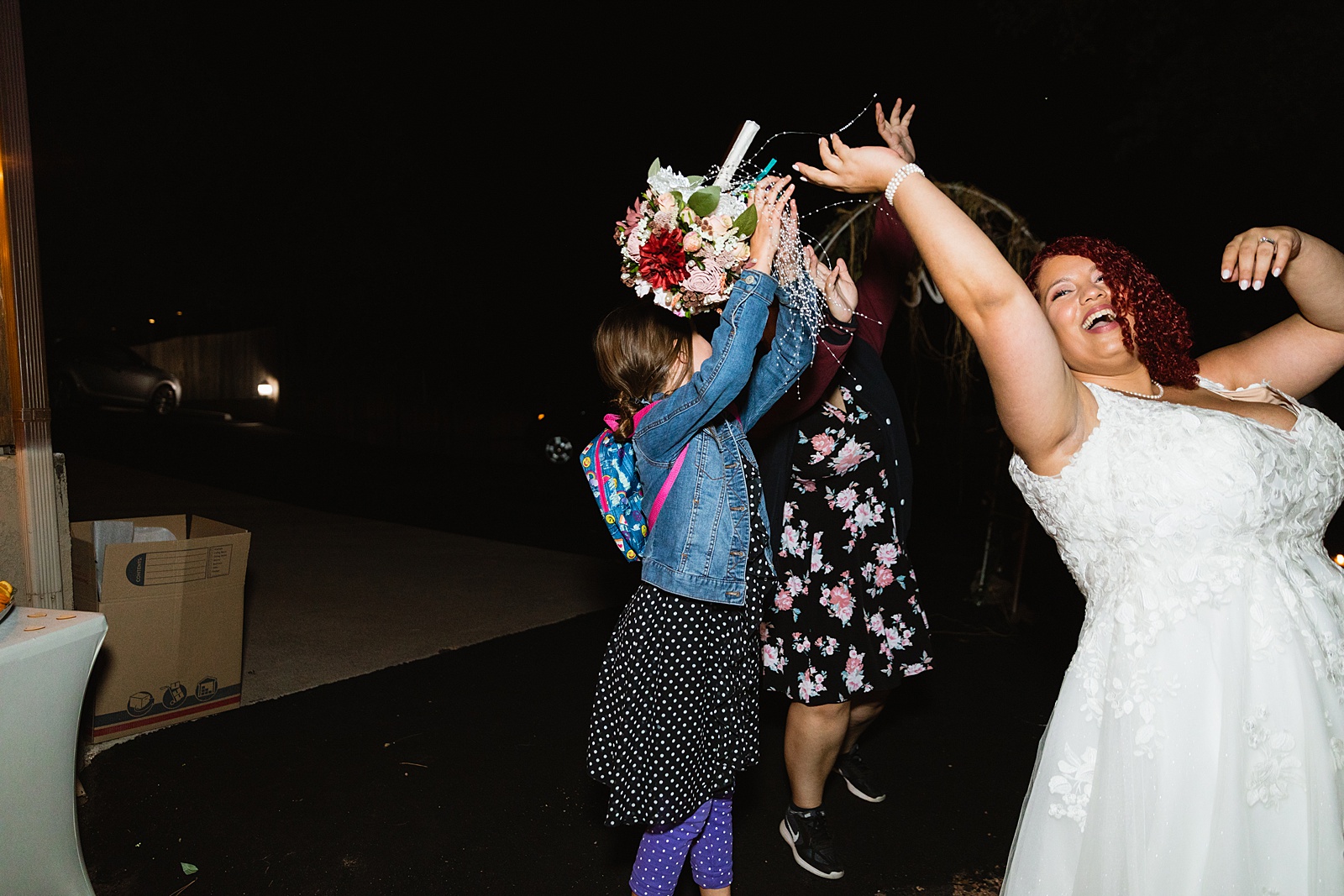 Bouquet toss at Mogollon Rim wedding reception by Northern Arizona wedding photographer PMA Photography.