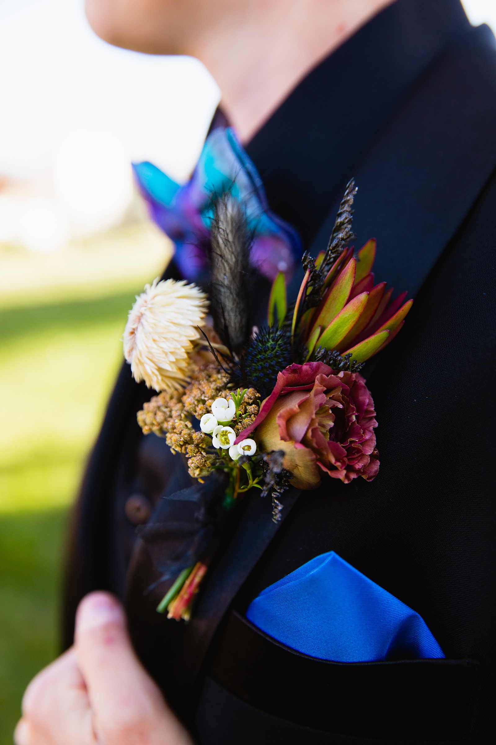 Brides's wedding day details dried flower and rose boutonniere and purple pocket square by PMA Photography.