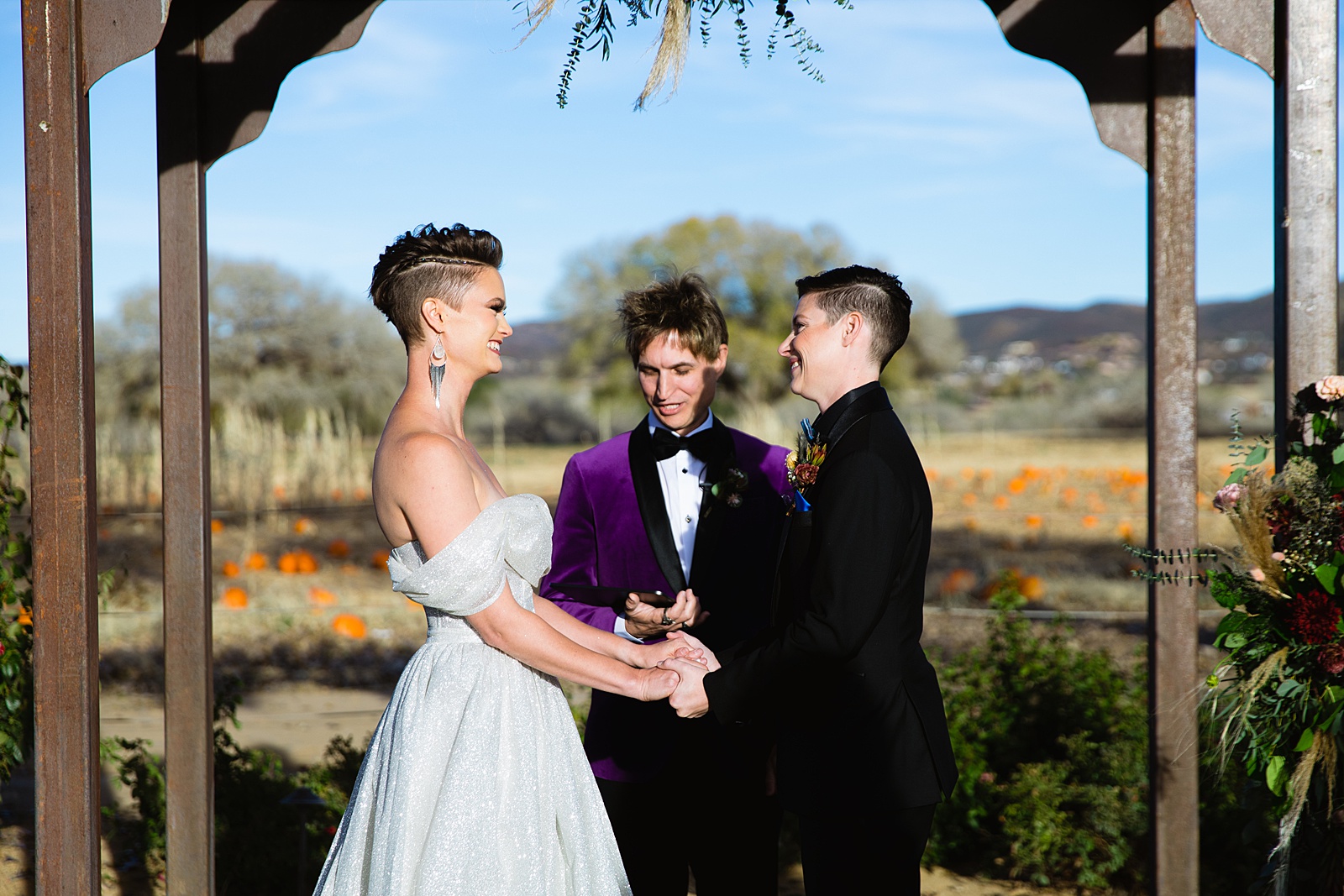 Same sex couple exchange vows during their Mortimer Farms wedding ceremony by Prescott wedding photographer PMA Photography.