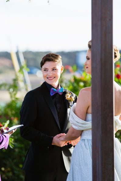Same sex couple togethering during Mortimer Farms wedding ceremony by Prescott wedding photographer PMA Photography.