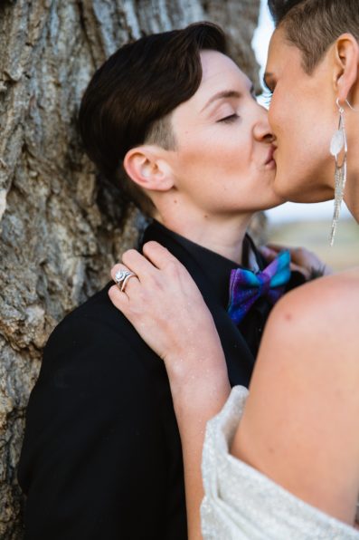 Same sex couple share a passionate kiss during their Mortimer Farms wedding by Arizona wedding photographer PMA Photography.