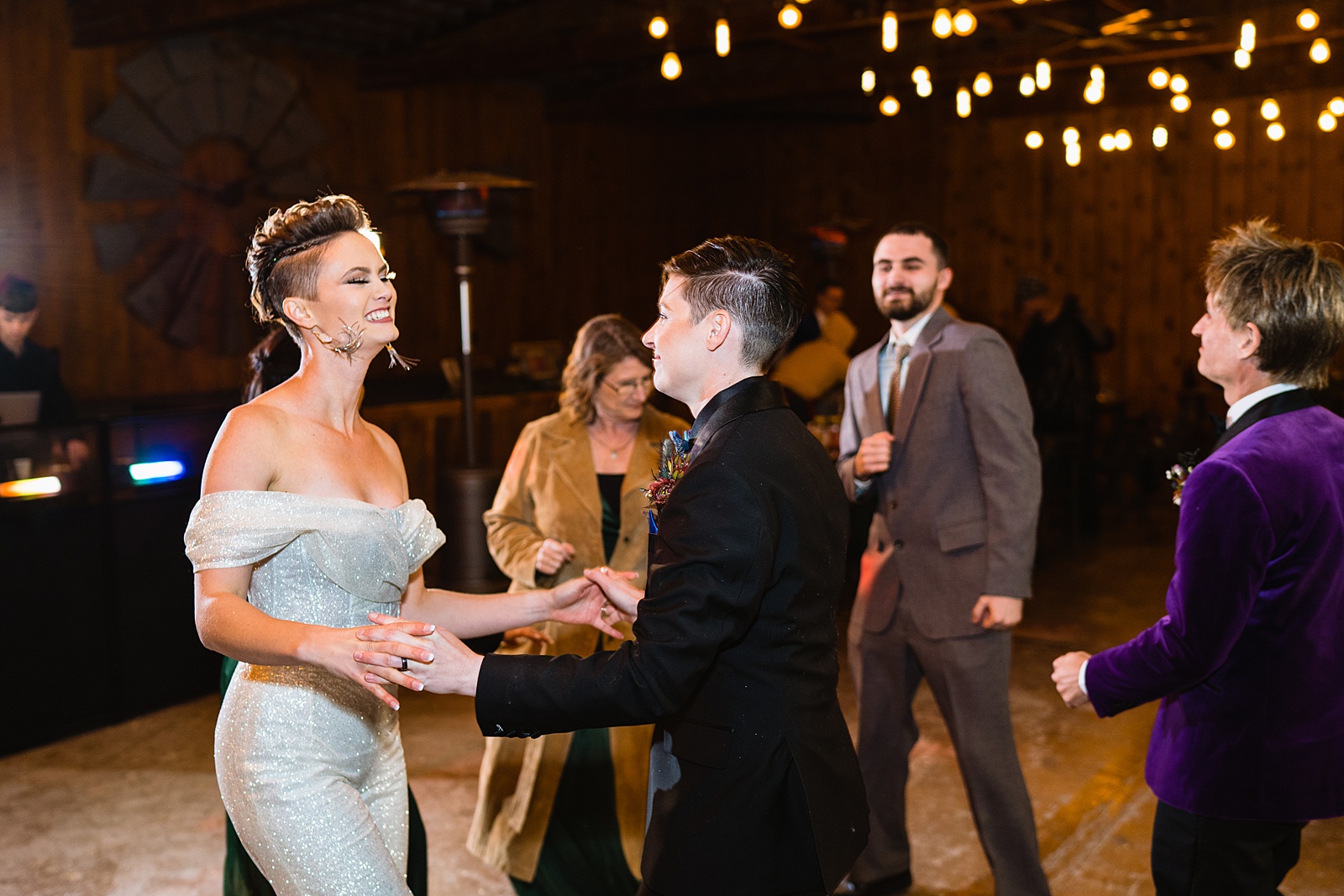 Brides dancing with guests at Mortimer Farms wedding reception by Prescott wedding photographer PMA Photography