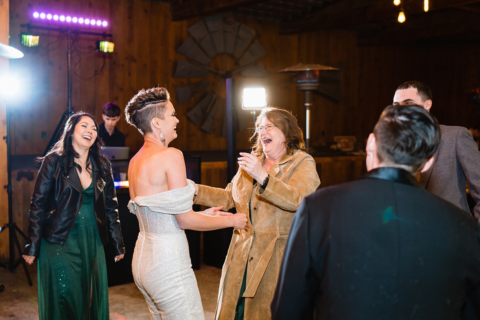 Bride dancing with guests at Mortimer Farms wedding reception by Prescott wedding photographer PMA Photography