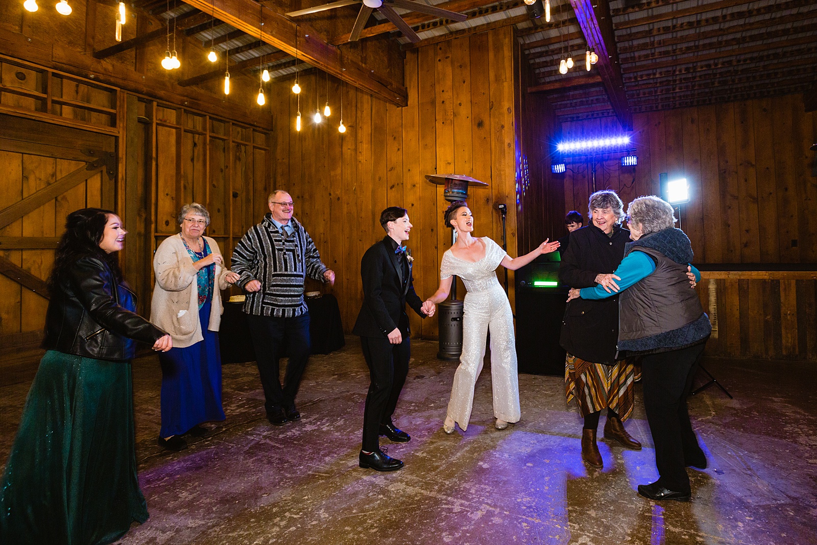 Brides dancing with guests at Mortimer Farms wedding reception by Prescott wedding photographer PMA Photography