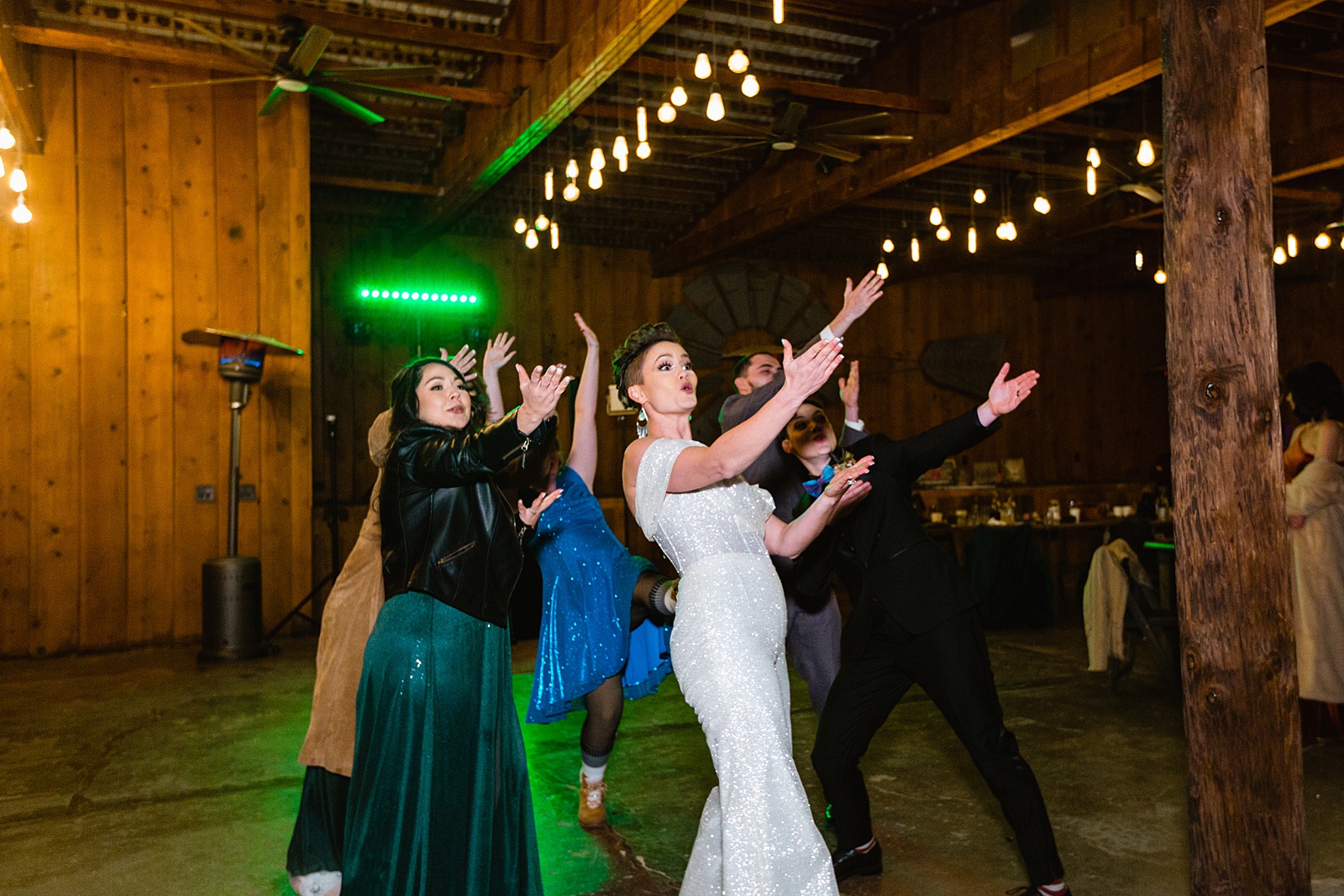 Same sex couple dancing with guests at their Mortimer Farms wedding reception by Arizona wedding photographer PMA Photography