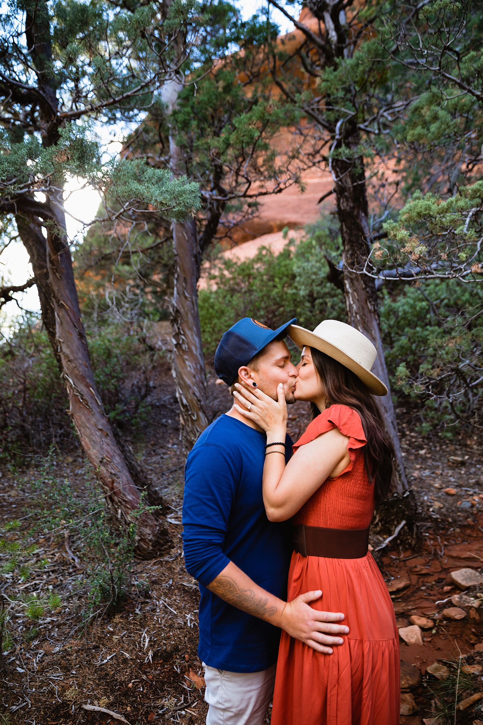 Adventurous couple share a kiss during their Merry Go Round engagement session by Sedona wedding photographer PMA Photography.
