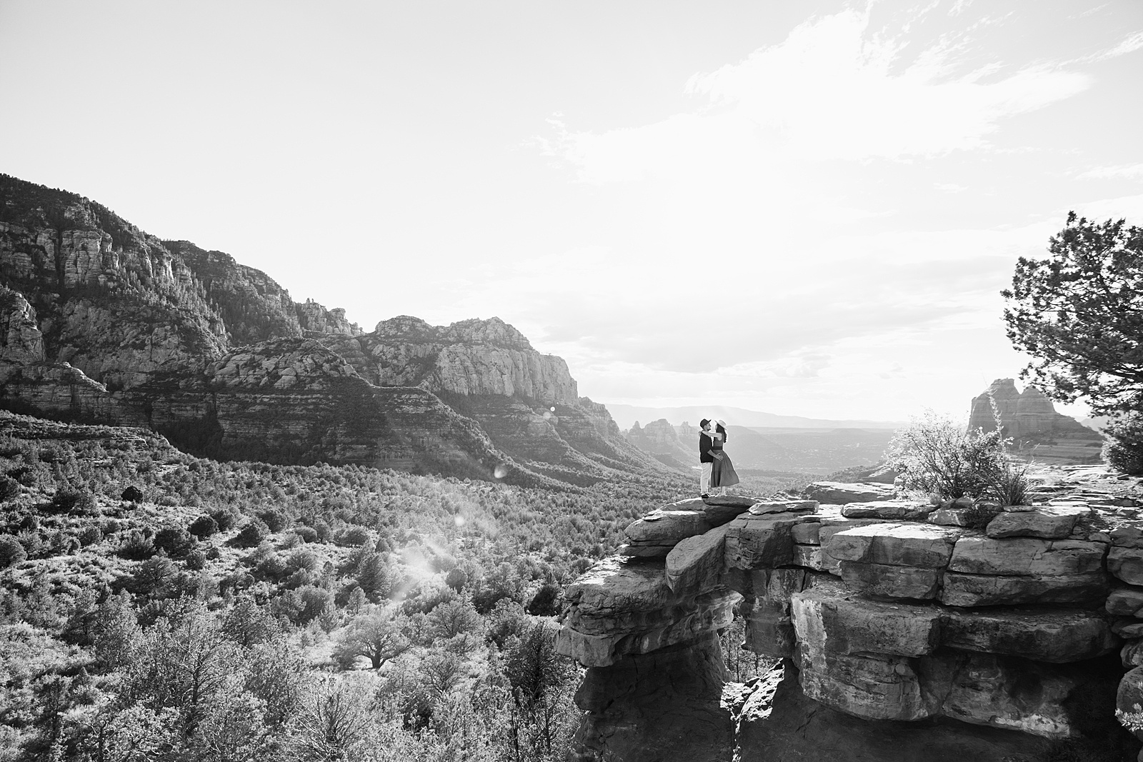 Adventurous couple pose for their Merry Go Round Rock engagement session by Sedona wedding photographer PMA Photography.
