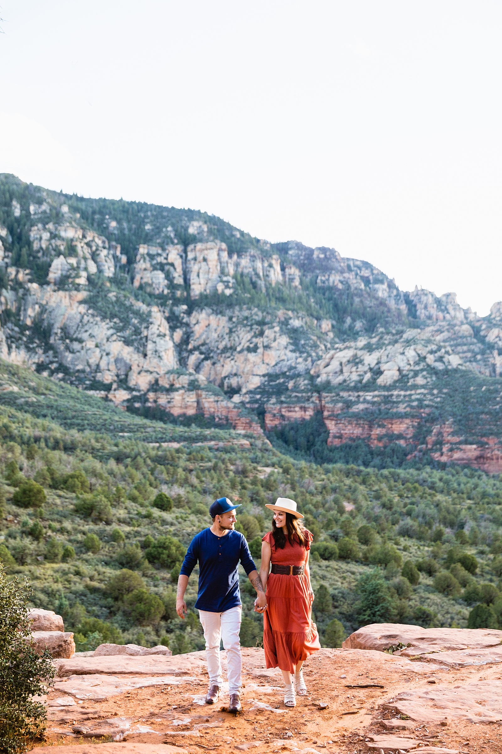 Couple walking together during their Sedona engagement session by Arizona engagement photographer PMA Photography.