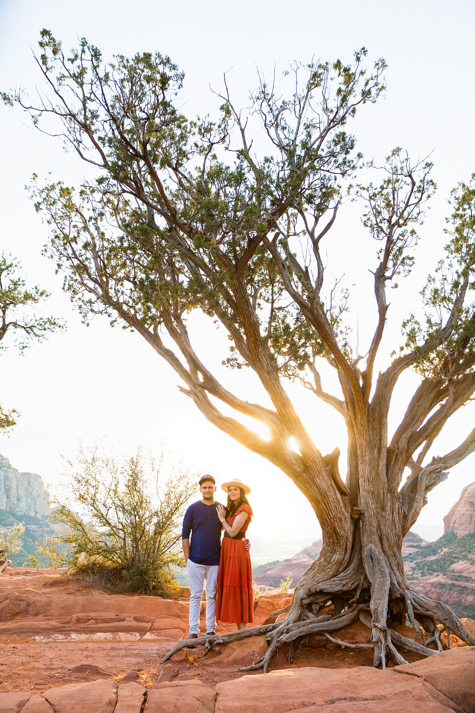 Couple pose for their Merry Go Round Rock engagement session by Sedona wedding photographer PMA Photography.
