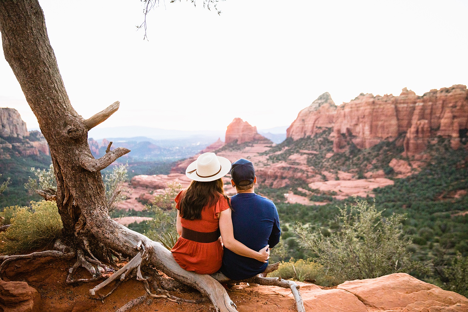 Couple share an intimate moment at their Sedona engagement session by Arizona engagement photographer PMA Photography.