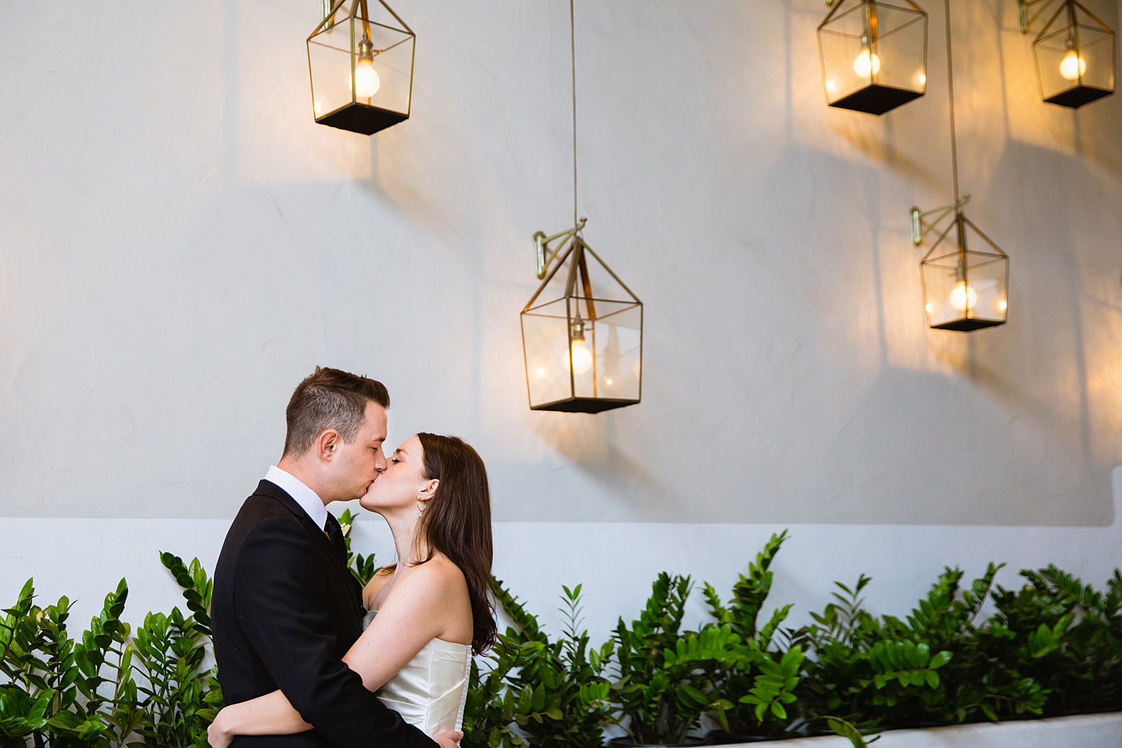 Bride & Groom share a kiss during their The Scott wedding by Scottsdale wedding photographer PMA Photography.