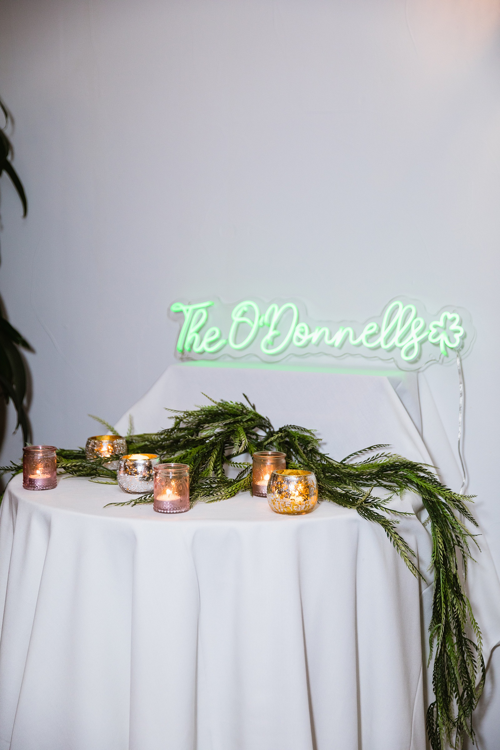 Green neon sign reception decorations at The Scott wedding reception by Scottsdale wedding photographer PMA Photography.