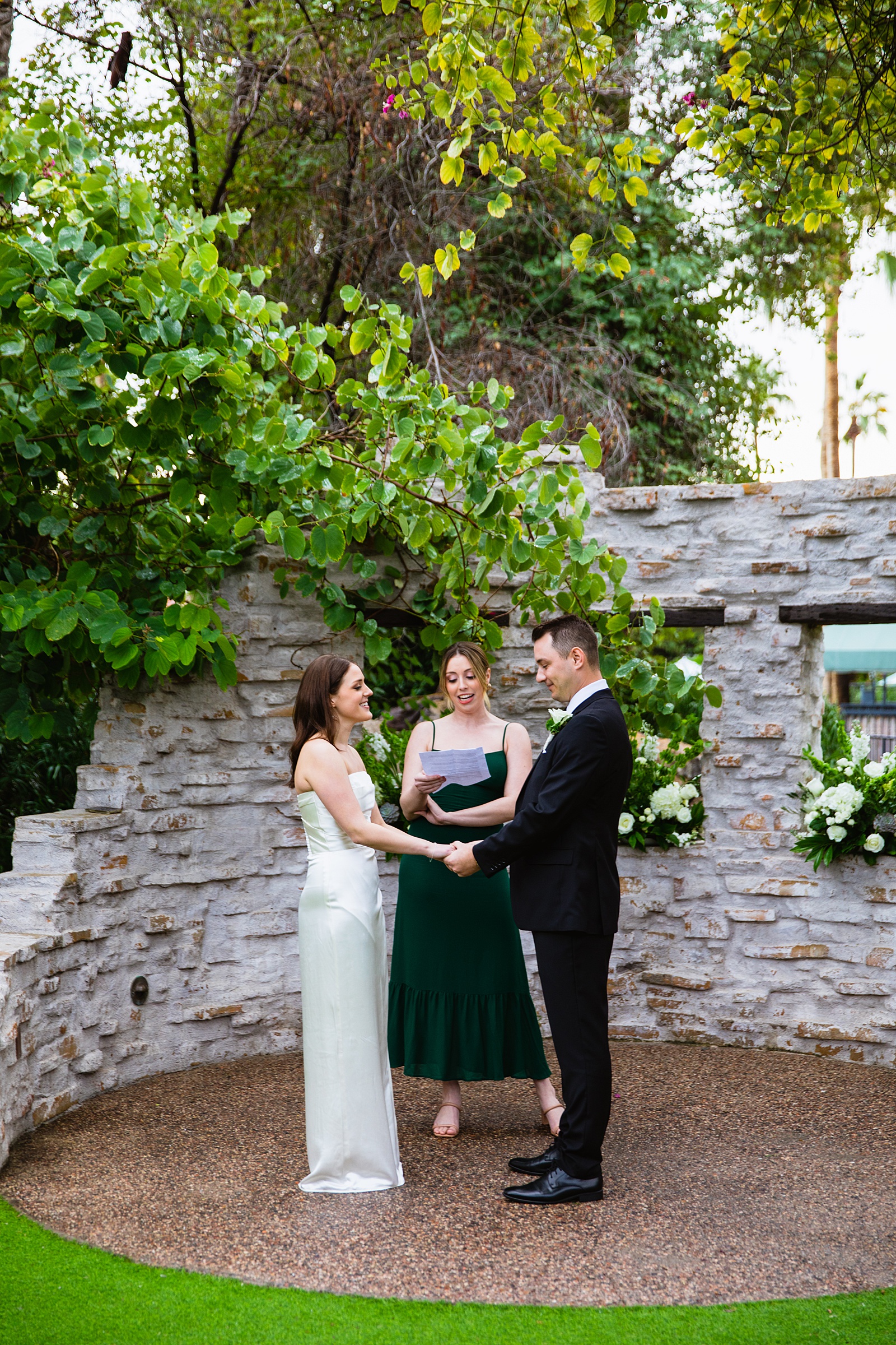 Bride & Groom exchange vows during their The Scott wedding ceremony by Scottsdale wedding photographer PMA Photography.