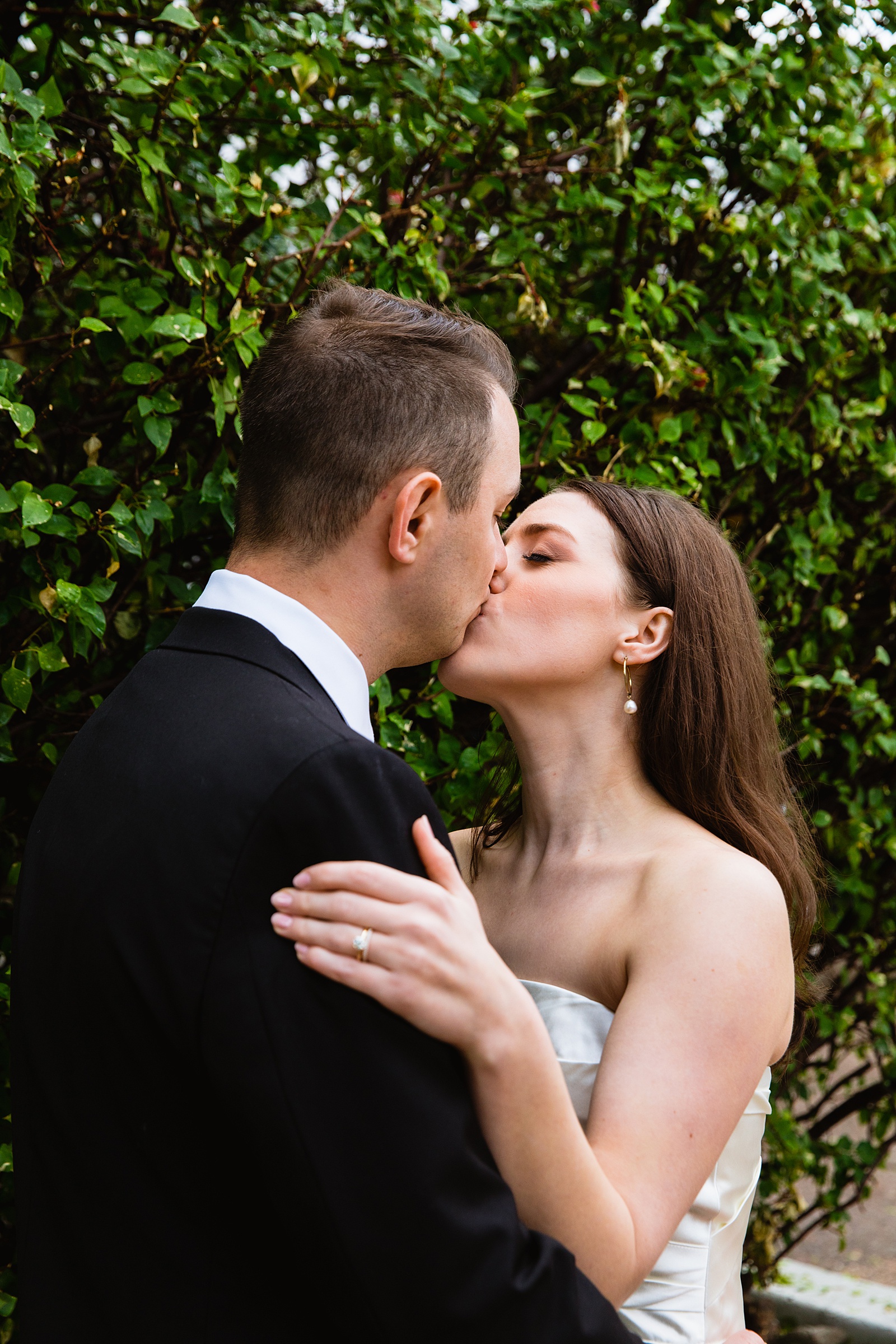 Bride & Groom share a kiss during their The Scott wedding by Scottsdale wedding photographer PMA Photography.