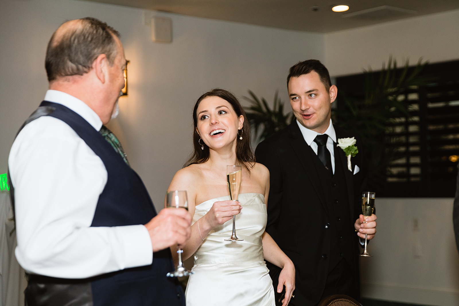 Guests make a toast at The Scott wedding reception by Scottsdale wedding photographer PMA Photography