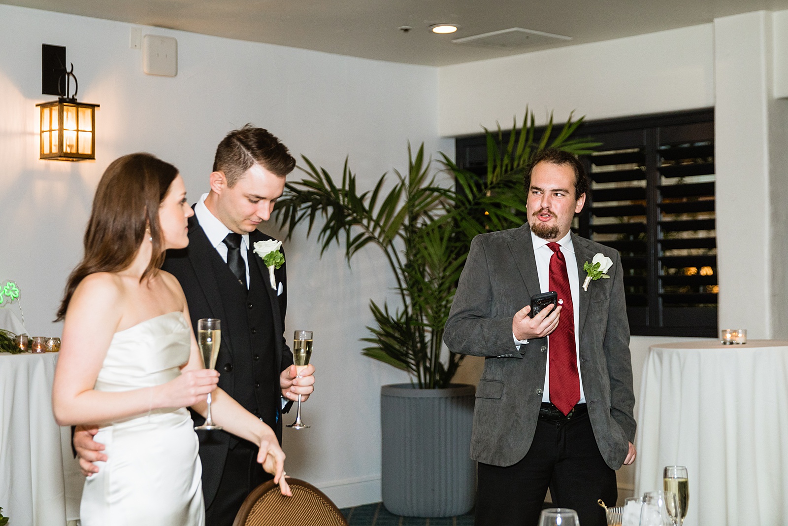 Guests make a toast at The Scott wedding reception by Scottsdale wedding photographer PMA Photography.