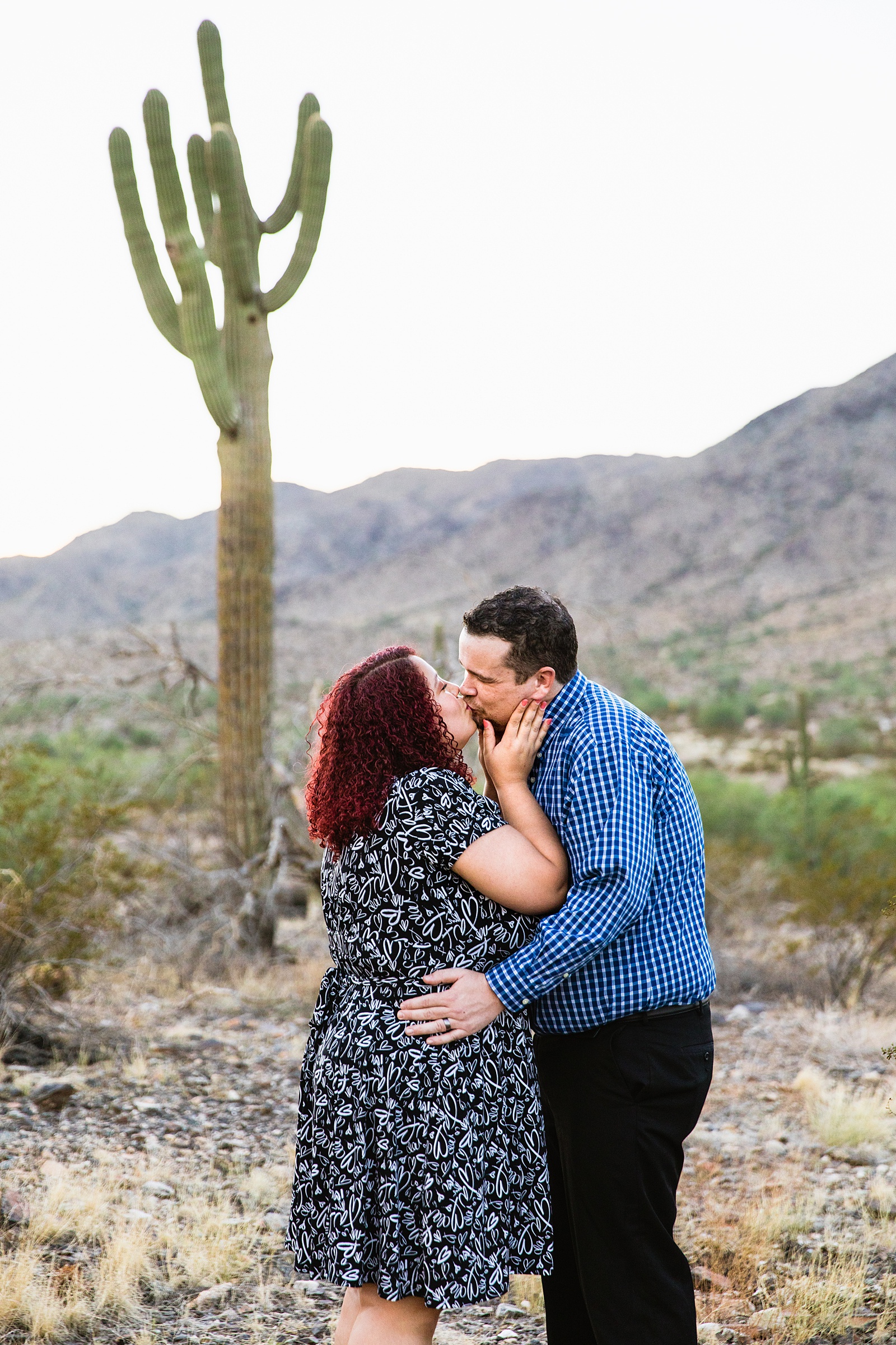 Couple share a kiss during their South Mountain engagement session by Phoenix wedding photographer PMA Photography.