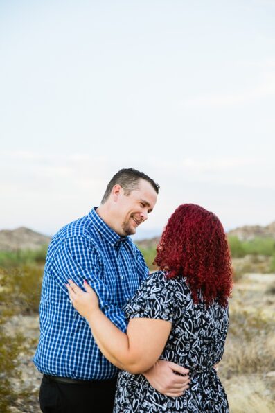 Adventurous couple laugh together during their Phoenix engagement session by Arizona engagement photographer PMA Photography.
