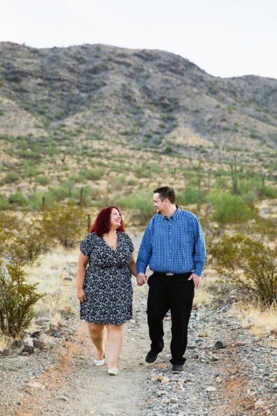 Adventurous couple walking together during their Phoenix engagement session by Arizona engagement photographer PMA Photography.