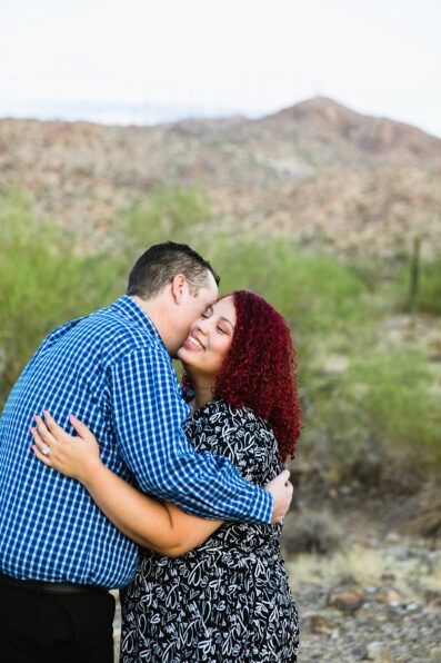 Adventurous couple laugh together during their South Mountain engagement session by Phoenix engagement photographer PMA Photography.