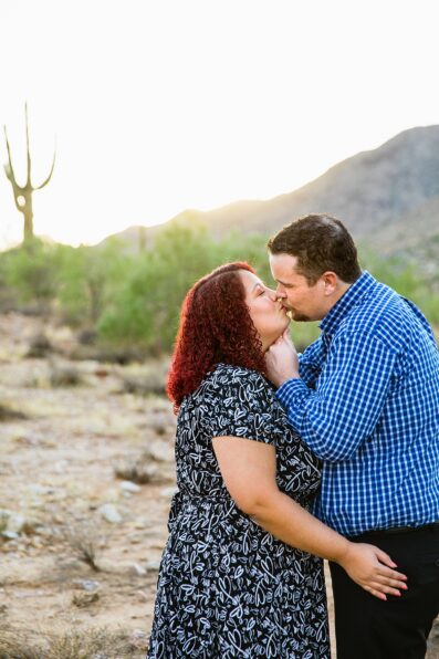Couple share a kiss during their South Mountain engagement session by Phoenix wedding photographer PMA Photography.
