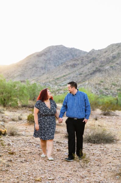 Adventurous couple walking together during their Phoenix engagement session by Arizona engagement photographer PMA Photography.