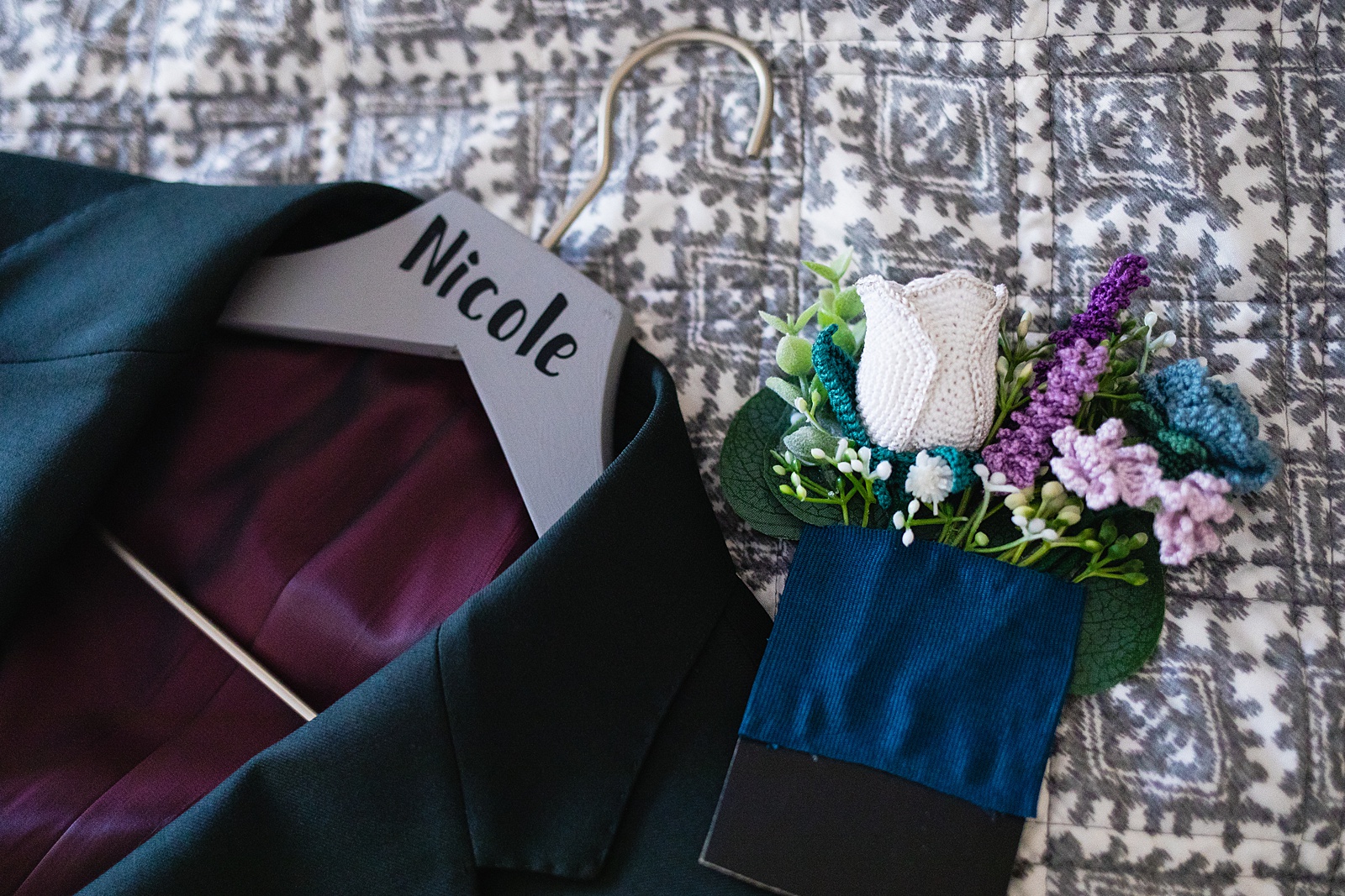 Groom's wedding day details of handmade crochet flowers and jacket by PMA Photography.